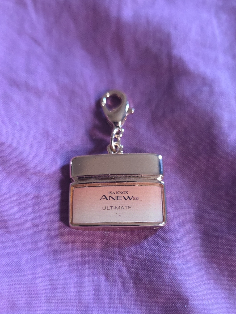 Avon Anew Ultimate Gold Isa Knox .5" Jar Charm Bracelet / Necklace / Keychain